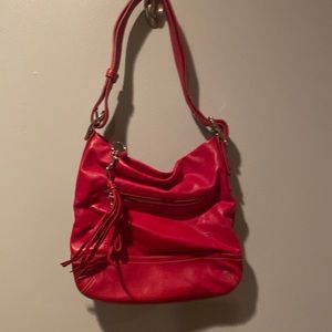 Red Leather Coach Handbag with Tan Logo Interior and Silver Hardware.